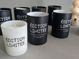 candles are lined up on a table in front of a box