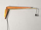 a wooden wall mounted lamp with a cord attached to it