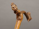 a close up of a wooden stick with a face on it