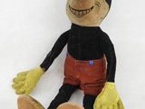 une peluche représentant un homme loufoque assis par terre