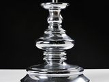 a glass candle that is sitting on a table