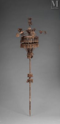 an image of a wooden sculpture of a bird on a pole