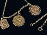 two gold and silver necklaces with a coin on a chain