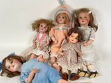 a lot of dolls that are laying on the ground