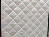 a mattress that has been wrapped up and is sitting on the floor