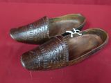 pair of brown leather shoes with laces on them sitting on a red cloth