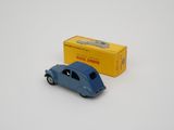 blue toy car sitting next to a yellow box on a white surface
