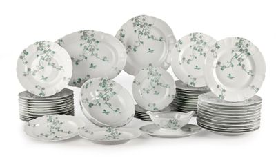 a pile of plates and bowls with green flowers on them