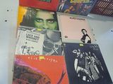 a lot of records on a table in a room