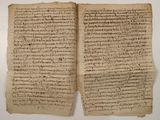 an old manuscript with writing on it sitting on top of a table