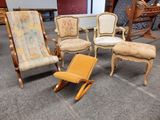 four chairs and a chair that are sitting in a room