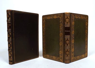two old books sitting side by side on a white surface