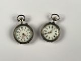pair of antique pocket watches with roman numerals and roman numerals