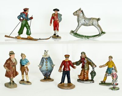 many figurines of people on display on a shelf