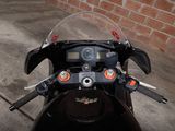 a motorcycle that is parked in front of a brick wall
