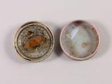 a small container with a small object inside of it