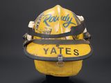 yellow fireman ' s helmet with the word vote written on it