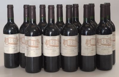 six bottles of wine are lined up in a row on a table