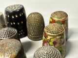 five thimbles sitting next to each other on a white surface