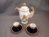 two cups and a teapot sitting on a table