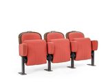 three red chairs sitting next to each other on a white surface