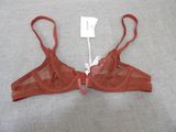 an image of a bra top with a red ribbon around it