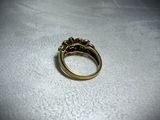 a close up of a gold ring on a white surface
