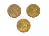 three different types of gold coins on a white surface