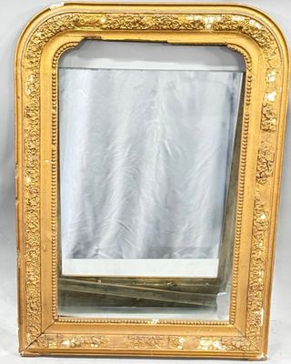 an image of a gold framed mirror sitting on top of a table