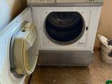 an image of a washing machine and a cat in a room