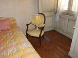 a bed and a chair in a small room
