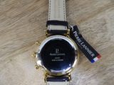a watch that is sitting on a wooden table