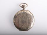 a silver pocket watch with a picture of a woman on it