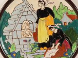 a plate with a painting of a woman and a man
