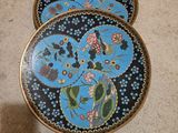 three decorative plates are sitting on the floor next to each other