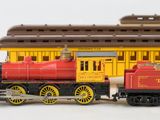 two toy trains that are sitting on a white surface