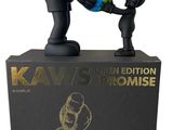 black and gold kaws limited edition statue of a boy and a girl holding a globe