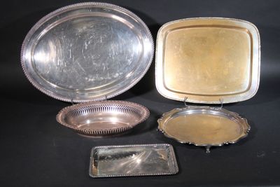 three silver trays and a silver tray on a black surface