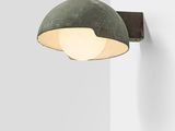 a close up of a light on a wall next to a wall