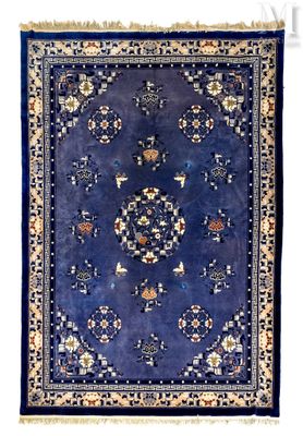 a blue rug with a medallion design on it