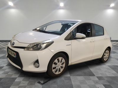 the toyota yaris is parked in a clean room with checkered flooring
