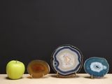 three agite slices and an apple sit on a table