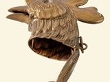 a metal object that looks like a fish with a mouth