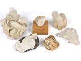 a group of rocks and crystals sitting on top of a wooden block