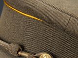 an image of a military hat with a gold button on it