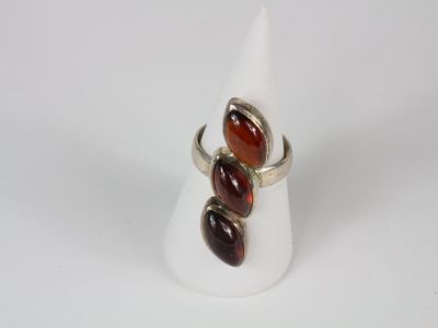 a close up of a ring with two stones on it