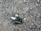 an overhead view of a skateboard laying on the ground with a cord attached to it