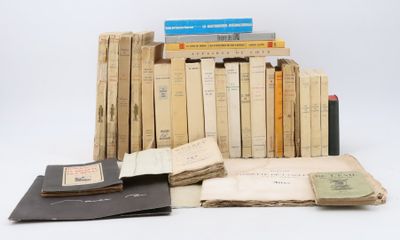 several books are stacked on top of each other on a white surface