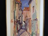 framed watercolor painting of a narrow street in a small town