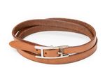 a close up of a brown leather bracelet on a white background